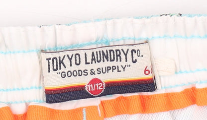 Brand and care label for Tokyo Laundry boys’ blue swim shorts 11 years, beach pattern