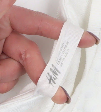 Brand and care label for H&M girls’ white sequin pullover sweatshirt, size 12