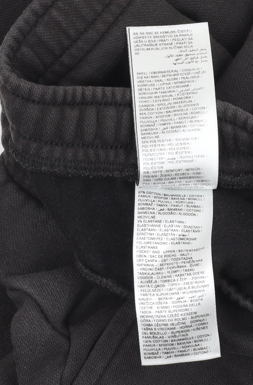 Close-up detail of Puma boys’ black jogger trousers, size 7-8, years