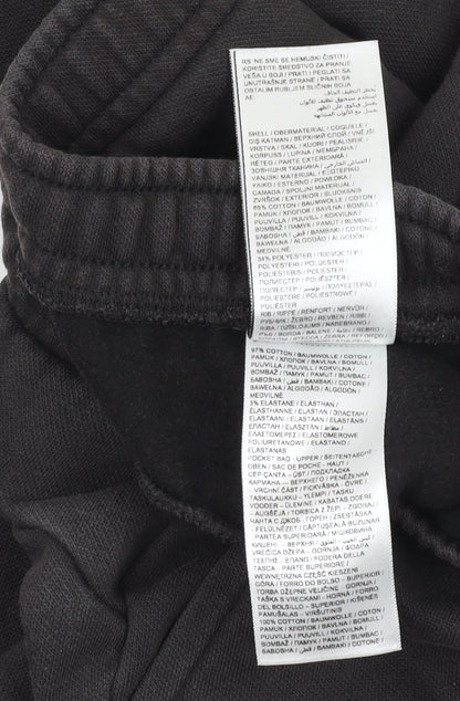 Close-up detail of Puma boys’ black jogger trousers, size 7-8, years