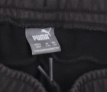 Brand and care label for Puma boys’ black jogger trousers, size 7-8, years