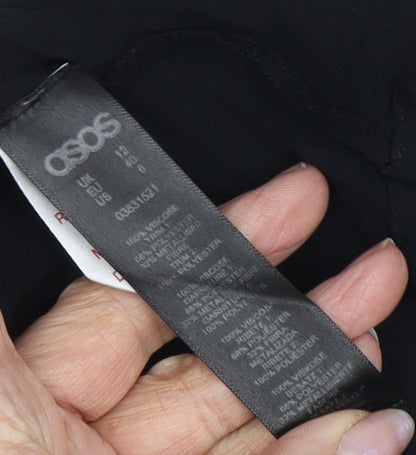 Close-up detail of ASOS Women's Black Tunic Blouse, size 12, - Tasselled & Elegant