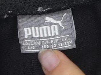 Close-up detail of Puma boys’ black joggers l tapered sports trousers