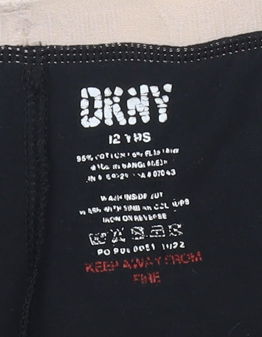 Close-up detail of DKNY girls’ black ankle leggings, cotton blend, 12 years