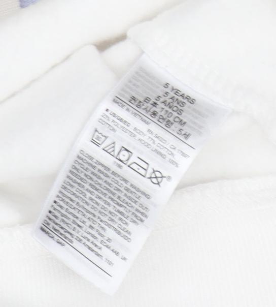 Brand and care label for Gap girls’ full zip white hoodie with rainbow logo, size 5