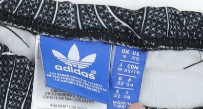 Close-up detail of Adidas Women's XS Black Track Pants with Geometric Pattern