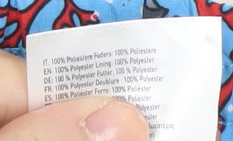 Brand and care label for Zoggs boys’ blue fish print swim shorts 2 years quick dry