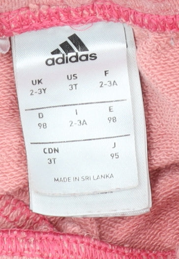 Brand and care label for Adidas girls’ pink jogger trousers 2-3 years