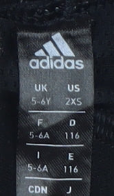 Close-up detail of Adidas girls’ black compression leggings 5-6y athletic fit