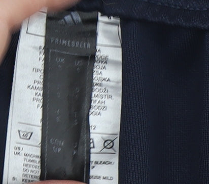 Close-up detail of Adidas boys’ black track pants, size S, sportswear essentials