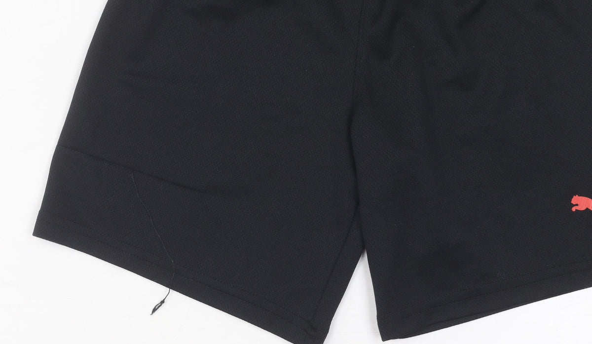 Close-up detail of Puma boys’ black athletic shorts xs