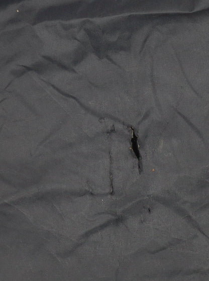 Close-up detail of Trespass boys’ black windbreaker jacket, size 9-10