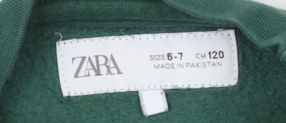 Brand and care label for Zara boys’ green crew neck pullover sweatshirt, size 6-7