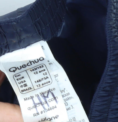 Close-up detail of Quechua boys’ blue rain trousers, size 12, for hiking