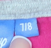Brand and care label for Disney girls’ pink frozen t-shirt, size 7-8, years, long sleeve