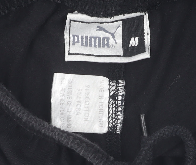 Brand and care label for Puma boys’ black compression shorts m