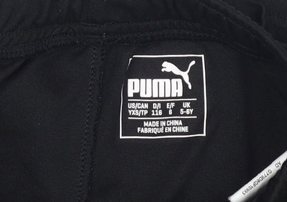 Close-up detail of Puma boys’ black athletic shorts, size 5-6, years