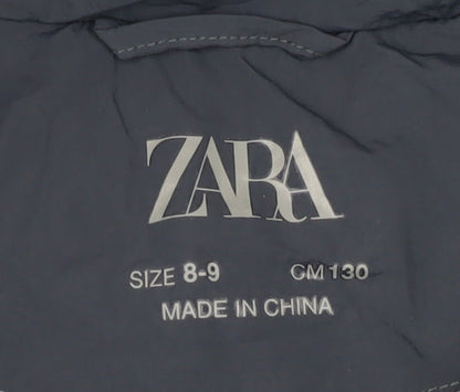 Brand and care label for Zara girls’ blue puffer jacket 8-9 years
