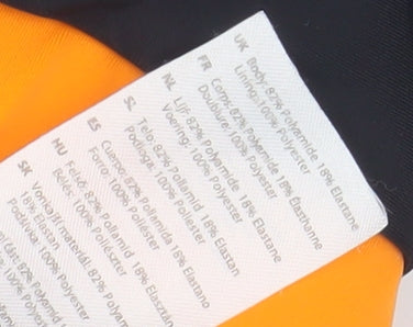 Brand and care label for Star Wars boys’ swim shorts, black/orange, 11-12 years
