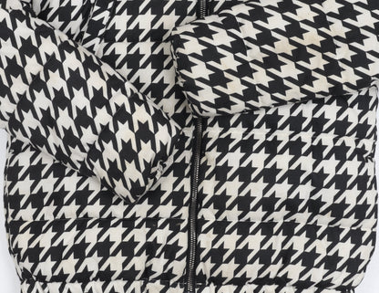 Close-up detail of Next girls’' black white houndstooth puffer jacket 11y