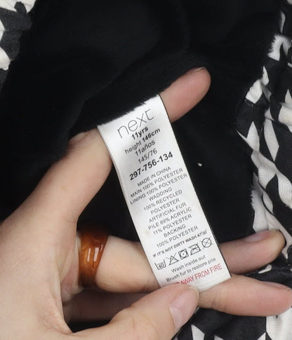 Brand and care label for Next girls’' black white houndstooth puffer jacket 11y