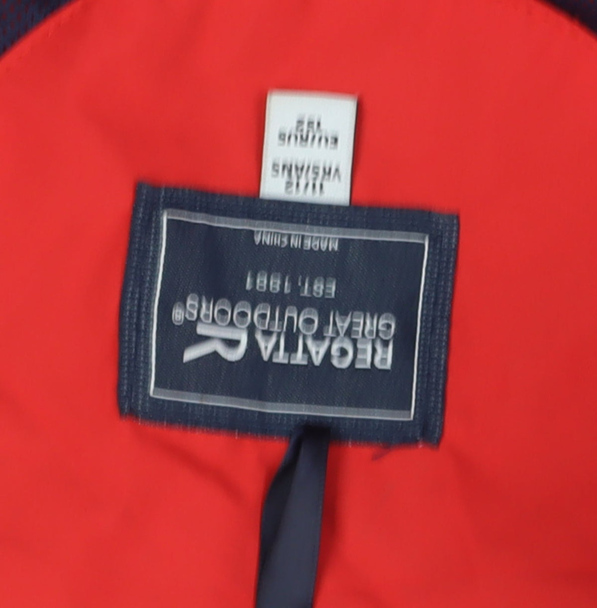 Close-up detail of Regatta boys’ red blue windbreaker jacket hooded 14 years