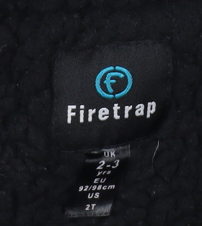 Brand and care label for Firetrap boys’ camouflage rain coat 2-3 years