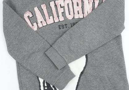 Close-up detail of Peanuts girls’' grey snoopy sweatshirt, 9 years, pullover style