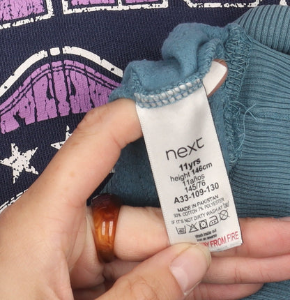 Brand and care label for Next girls’ blue graphic sweatshirt, 11 years