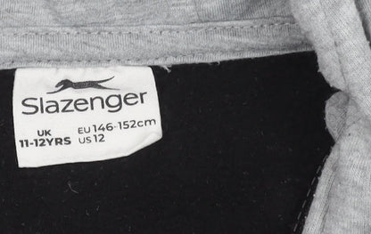 Brand and care label for Slazenger boys’' black basic jacket, hooded, 11-12 years