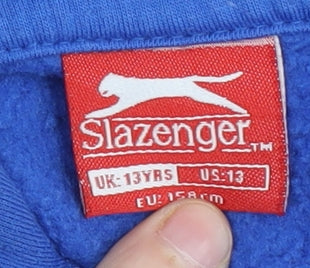 Brand and care label for Slazenger boys’ blue pullover hoodie, size 13, years