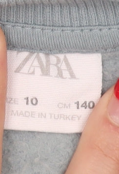 Brand and care label for Zara boys’ blue pullover sweatshirt, 10 years, crew neck