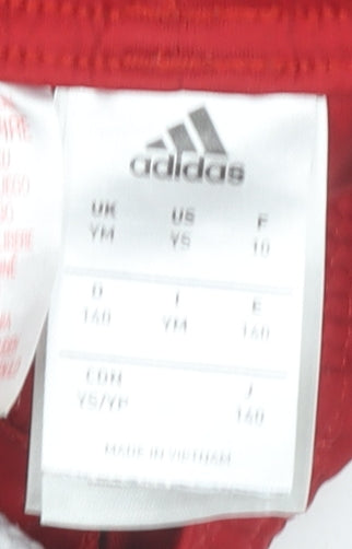 Close-up detail of Adidas boys’ red athletic shorts - gym & training