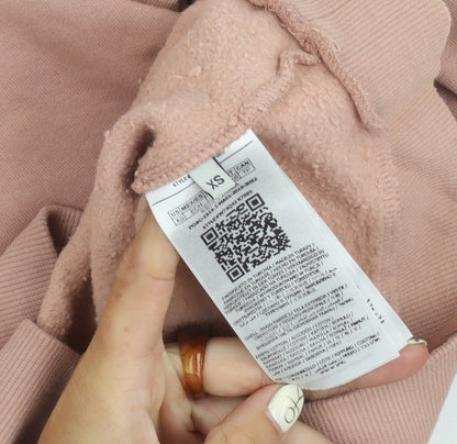 Close-up detail of Guess women’s pink logo pullover sweatshirt xs