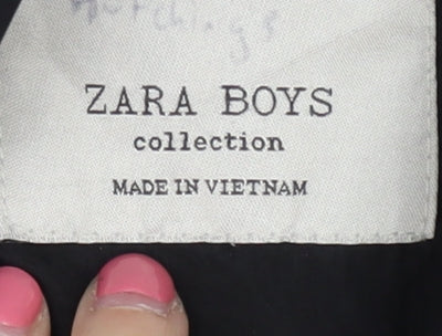 Brand and care label for Zara boys’ black hooded jacket, size 5, years with button accents