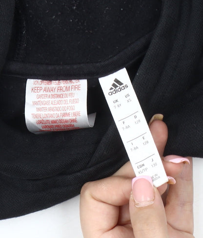 Close-up detail of Adidas boys’ black pullover hoodie, xs, logo accent