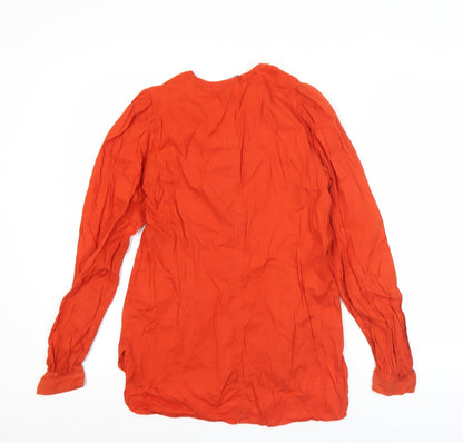 Close-up detail of French Connection women’s red cotton tunic blouse, size UK 10