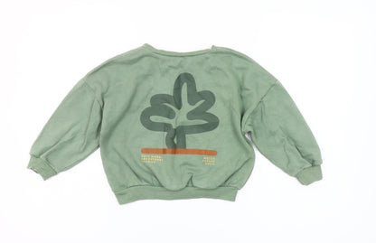 Close-up detail of Dunnes girls’ green pullover sweatshirt 4-5 years nature print