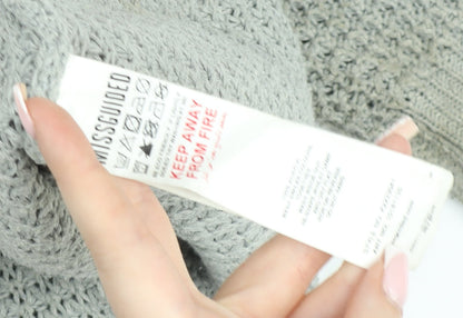 Brand and care label for Missguided Women’s Grey Open-Knit Boat Neck jumper, size UK 10/12