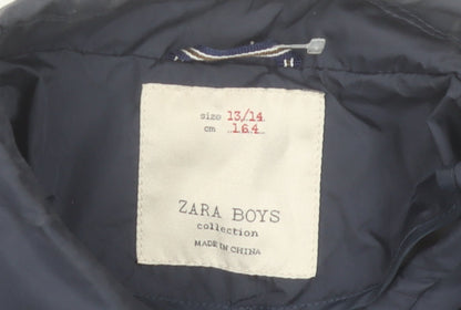 Brand and care label for Zara boys’ blue polyurethane mid-length jacket 13-14 years