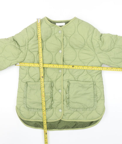 Back view of Leigh Tucker Willow girls’ green quilted ruffle jacket 8-9 years