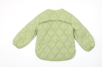Close-up detail of Leigh Tucker Willow girls’ green quilted ruffle jacket 8-9 years