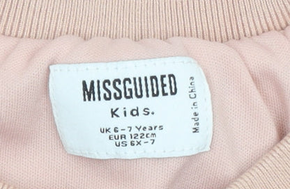Brand and care label for Missguided girls’ pink fleece pullover sweatshirt 6-7 years