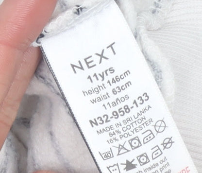 Brand and care label for Next girls’ beige striped sequin pullover sweatshirt 11 years 146cm