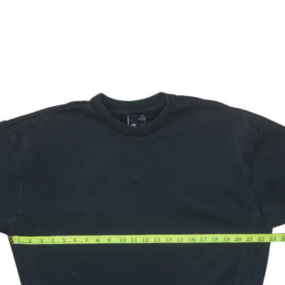 Close-up detail of Adidas women’s black crew neck pullover sweatshirt, size M