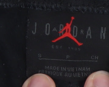 Brand and care label for Jordan Men's Black Regular Fit Sweatpants Small with Gold Logo