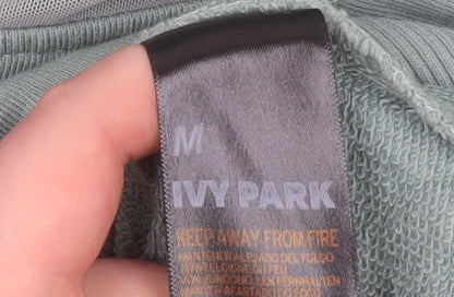Brand and care label for Ivy Park Women's Green Pullover Hoodie Medium Cotton Blend Logo Sweatshirt