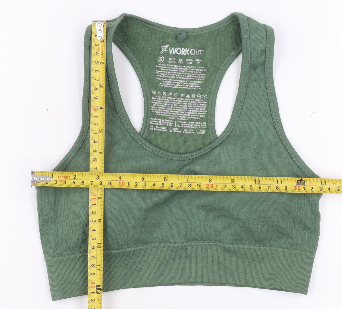 Prewornwholesale green racerback sports bra with medium support and seamless construction for activewear.