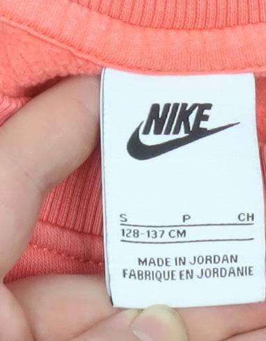 Brand and care label for Nike girls’ pink crew neck pullover sweatshirt, size S, 128-137cm