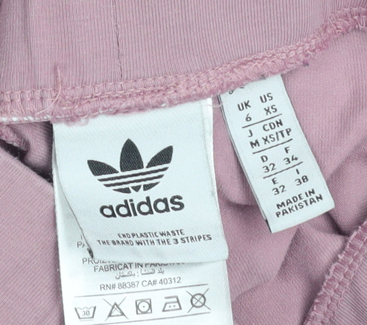 Brand and care label for Adidas Women’s Pink Leggings XS Cotton Stretch Side Stripe